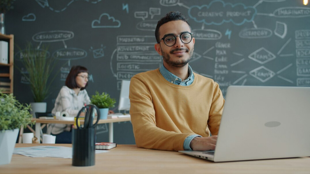 young entrepreneur using laptop with ai