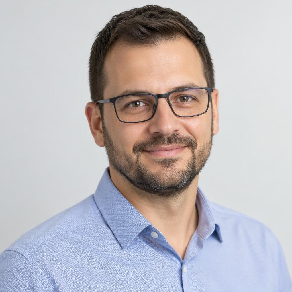 Portrait of a Croatian man AI educator with a beard and glasses
